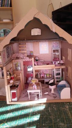 a doll house with furniture and accessories inside