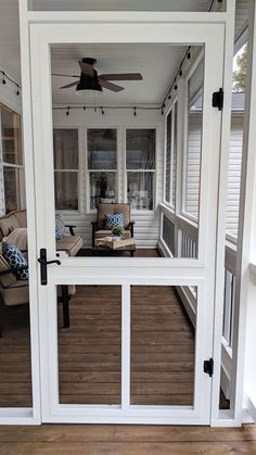 a screened porch with sliding glass doors leading into the living room