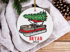 a personalized ornament with a boat and christmas tree