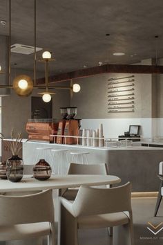 a dining room table with chairs and lights hanging from it's ceiling over the counter