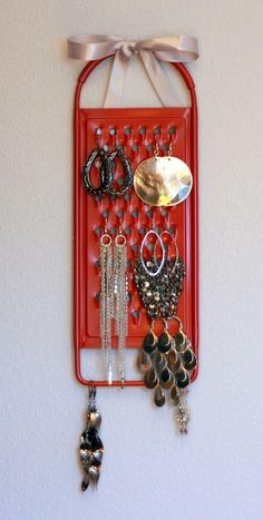 a red tray with jewelry hanging from it