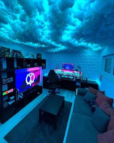 a living room filled with furniture and a flat screen tv mounted to the ceiling under a cloudy blue sky