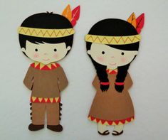 two paper dolls made to look like native americans are standing next to each other on a white surface