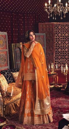 Orange Sharara Pakistani Bridal, Bridal Jaggo Outfit, Pakistani Sangeet Outfits, Farshi Gharara Pakistani Bridal, Mayoon Outfits Pakistani, Orange Traditional Outfits, Dholki Outfit Bride, Jaago Outfit Ideas, Wedding Sangeet Outfits