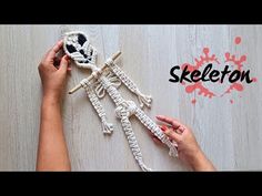 the skeleton is being made with yarn and crochet, while someone's hands are