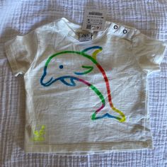 Zara Boys Or Girls Dolphin T Shirt 3-6 Mo Nwt . Check Out Other Zara Items In My Closet As Well As Other Designer Kids Items In Various Sizes To Pair With. Bundle And Save On Shipping . Thank You Unisex White T-shirt For Playtime, White Crew Neck T-shirt For Playtime, White Cotton T-shirt For Playtime, Unisex White T-shirt For Spring, White Graphic Tee For Playtime, Cute Zara Cotton Shirt, White Short Sleeve T-shirt For Playtime, Zara Cotton Tops For Playtime, White Crew Neck T-shirt For Playwear