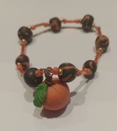 Pumpkin bracelet: Made with Halloween/ Autumn inspired colours with a cute Handmade pumpkin charm. elastic so can stretch to size. 🎃 Handmade Stretch Bracelet For Halloween, Halloween Gift Stretch Bracelet, Orange Halloween Gift Bracelet, Handmade Orange Bracelets For Halloween, Handmade Orange Novelty Bracelets, Handmade Orange Stretch Bracelet, Pumpkin Bracelet, Halloween Autumn, Autumn Inspired