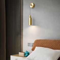 a bedroom with a bed, night stand and two lights on the wall above it