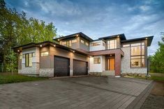 a large house with lots of windows and lights on it