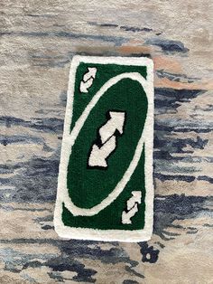 a green and white patch with arrows on it