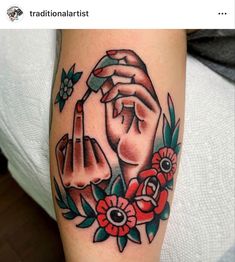 a woman's arm with flowers and two hands on it