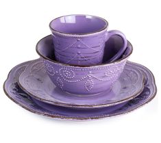 a purple cup and saucer sitting on top of each other