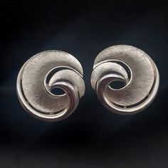 These vintage Trifari clip on earrings feature brushed silver tone swirls and measure 1" D. They are signed with the crown Trifari mark on the clip on closure. Retro Silver Metal Clip-on Earrings, Silver Retro Metal Clip-on Earrings, Retro Silver Clip-on Earrings For Wedding, Silver Retro Clip-on Earrings For Wedding, Vintage Trifari, Crown Trifari, Kingston, The Crown, Vintage Signs