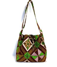 This beautiful 100% cotton African Print Bag is handmade with 100% cotton fabric, lining, and fusible fleece to give it a bit of a sturdy body. This bag can be used as a crossbody bag for women and also for teenagers to take to school. The size is perfect to use daily. All my bags and skirts are made in my pet-free and smoke-free home in Oxford Mississippi. MEASUREMENT: 12'' wide x 11.5'' height x 4 '' deep (gusset). FEATURES: *It has 2 slide pockets and 1 zipped pocket inside. *Closes with a dr Green Rectangular Bucket Bag For School, Brown Rectangular Cotton Hobo Bag, Rectangular Brown Cotton Hobo Bag, Green Cotton Hobo Bag For Travel, Square Bucket Bag With Adjustable Strap As Gift, Green Canvas Shoulder Bag Gift, Green Tote Shoulder Bag As Gift, Green Cotton Hobo Bag For Daily Use, Green Rectangular Bucket Bag For Gifts