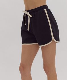 These soft and comfortable dolphin shorts feature a high waistline, self-tie at an elasticized waist and contrasting solid trim. Pair with the matching top for a chic set look or throw on with your favorite tee for lounge days or days on the go. 50% cotton, 43% polyester, 7% spandex Unlined, knit, non-sheer, lightweight Model is wearing a size small and is 5'10" FINAL SALE - CANNOT BE RETURNED OR EXCHANGED Black High Waisted Shorts, Dolphin Shorts, Contrasting Trim, Satin Midi Skirt, Autumn Gifts, Matching Top, Drawstring Shorts, Contrast Trim, Clothes Gift