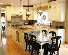 a kitchen with white cabinets and black chairs