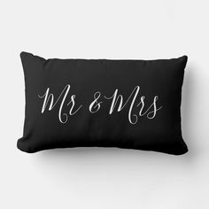 a black pillow with the word mrs and mrs written on it in cursive font