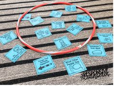 a red hoop with blue labels on it sitting on top of a striped rug next to a black and white floor