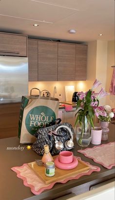 the kitchen counter is clean and ready to be used for cooking or baking, as well as flowers in vases