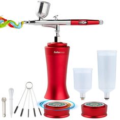 a red electric toothbrush holder and other items on a white background, including an empty cup