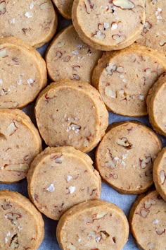 a pile of cookies with nuts on top