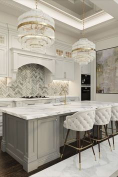 a large kitchen with marble counter tops and white cabinets, chandelier hanging from the ceiling