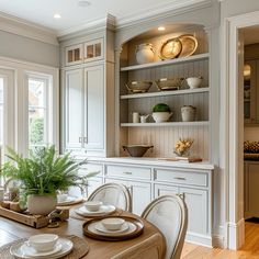 a dining room table with plates and bowls on it