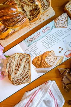 breads and pastries are sitting on the table next to each other, along with a recipe for chocolate bread