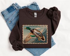 Duck hunting, duck hunter, duck hunter girlfriend, duck hunter wife, duck season, hunting wife, oversized boyfriend, hunting season, retro crewneck, vintage crewneck, gifts for duck hunter Ideal for any situation, a unisex heavy blend crewneck sweatshirt is pure comfort. These garments are made from polyester and cotton. This combination helps designs come out looking fresh and beautiful. The collar is ribbed knit, so it retains its shape even after washing. There are no itchy side seams on these sweaters.  .: Made with a medium-heavy fabric blend of 50% cotton and 50% polyester (8.0 oz/yd² (271.25 g/m this sweatshirt feels cozy and is the perfect choice for those colder months. .: The classic fit along with the crew neckline deliver a comfy wearing experience with a clean-cut style. Meanw Gifts For Hunting Boyfriend, Duck Clothing, Hunting Embroidery, Duck Sweater, Retro Crewneck, Aesthetic Cowgirl, Duck Stamp, Boyfriend Sweatshirt, Duck Season