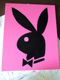 a pink and black painting with a rabbit's head in the middle on it