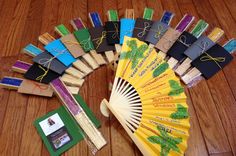 a yellow fan sitting on top of a wooden floor next to some books and other items