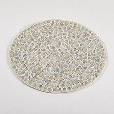 a white plate sitting on top of a table covered in lots of small dots and circles