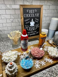 hot chocolates, marshmallows and other treats on a table