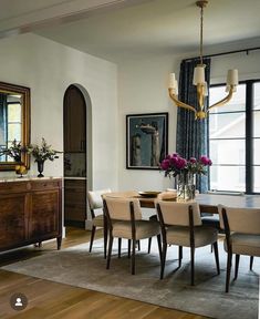 a dining room table with chairs and a chandelier