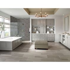 a large bathroom with white cabinets and gray tile flooring is pictured in this image