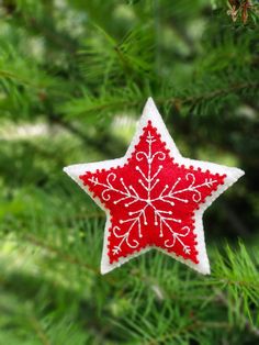 a red and white ornament hanging from a tree