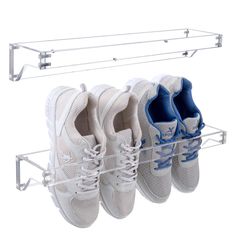 four pairs of tennis shoes hanging on a rack