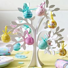 an easter tree with eggs in it on a table