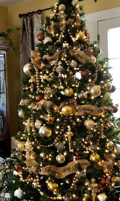 a christmas tree decorated with gold and silver ornaments