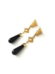 "Gorgeous Gold Tone Egyptian Revival Long Dangle Statement Earrings Beautiful earrings with great vintage inspired design. They have a gold triangular top that is softened at the corners with an open diamond shape gold connector which attaches to an \"onyx\" plastic bead. The look of the earrings is beautiful and they are very light weight bc the bead is plastic. They have a post stud back. They measure 2 3/4\" x 1/2\" Please read shop policies prior to purchase - thanks!" Elegant Triangle Metal Earrings, Elegant Triangle Earrings For Formal Occasions, Vintage Gold Teardrop Earrings For Party, Egyptian Revival, Vintage Inspired Design, Plastic Beads, Diamond Shape, Shop Policies, Diamond Shapes