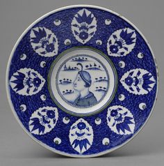 a blue and white plate with an image of a woman