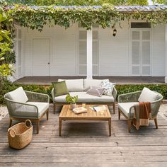 an outdoor living area with couches and chairs