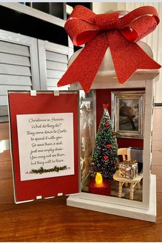 a small christmas tree in a miniature house with a poem written on the front door