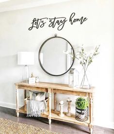 a living room with a mirror on the wall and plants in vases next to it