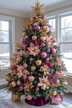 a christmas tree decorated with pink and gold ornaments