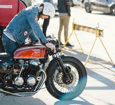 a man sitting on the seat of a motorcycle