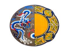 two different colored designs on the side of a circular object, one with a dragon