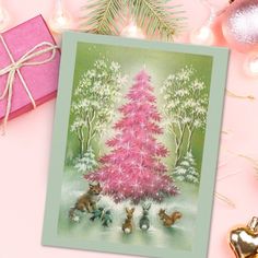 a pink christmas tree surrounded by other holiday decorations