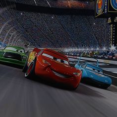 the cars are racing in front of an audience