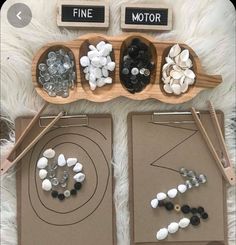 two wooden trays filled with rocks and magnets on top of a white rug